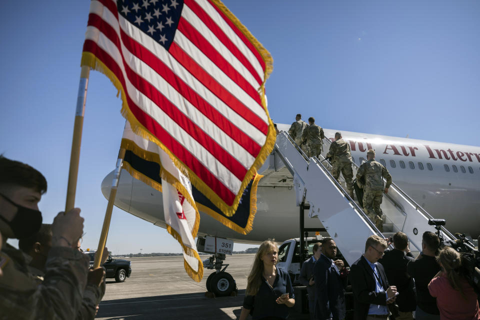 Over 180 soldiers with the U.S. Army 3rd Infantry Division, 1st Armored Brigade Combat Team climb the stairs to a charter airplane at Hunter Army Airfield during their deployment to Germany, Wednesday March 2, 2022 in Savannah, Ga. The division is sending 3,800 troops as reinforcements for various NATO allies in Eastern Europe. (Stephen B. Morton /Atlanta Journal-Constitution via AP)