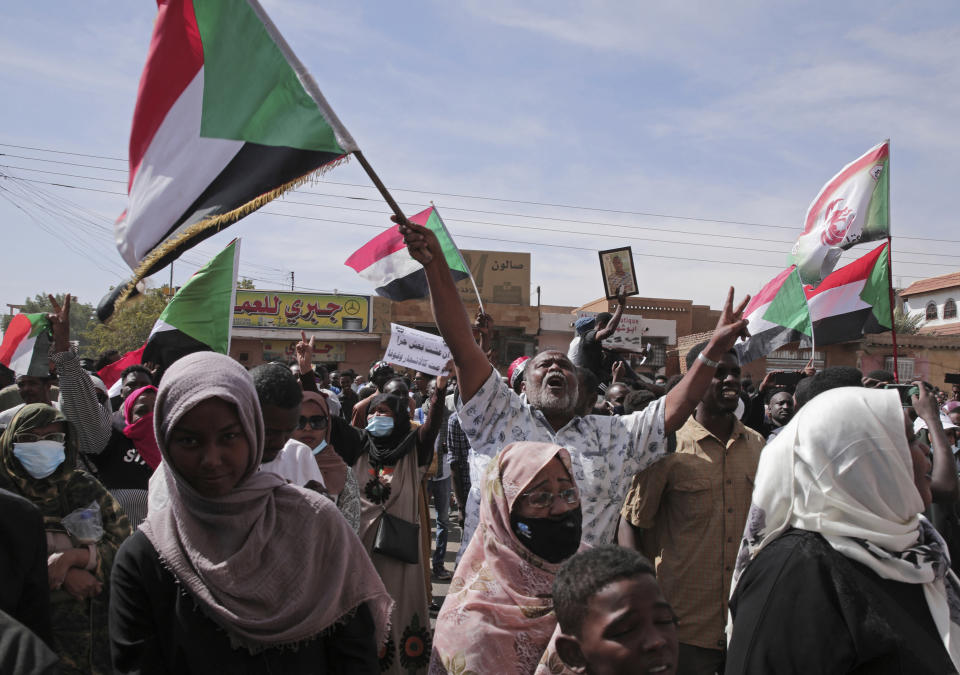 People chant slogans during a protest to denounce the October 2021 military coup, in Khartoum, Sudan, Sunday, Jan. 2, 2022. Sudanese security forces fired tear gas Sunday to disperse protesters as thousands rallied against military rule, medics said. (AP Photo/Marwan Ali)