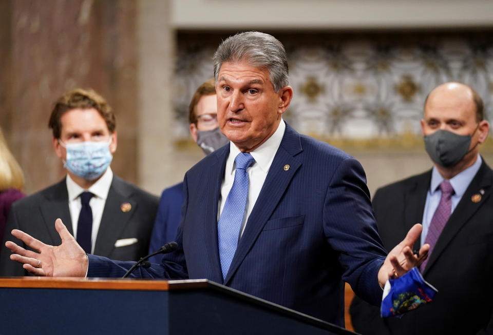 U.S. Senator Joe Manchin (D-WVA) removes his mask to speak as bipartisan members of the Senate and House gather to announce a framework for fresh coronavirus disease (COVID-19) relief legislation at a news conference on Capitol Hill in Washington, U.S., December 1, 2020. REUTERS/Kevin Lamarque