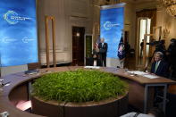 President Joe Biden speaks to the virtual Leaders Summit on Climate, from the East Room of the White House, Friday, April 23, 2021, in Washington, as Special Presidential Envoy for Climate John Kerry, looks on.