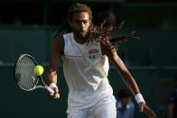 Dustin Brown of Germany hits a shot during his match against Rafael Nadal of Spain at the Wimbledon Tennis Championships in London, July 2, 2015. REUTERS/Stefan Wermuth