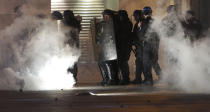 French riot police advances in a cloud of tear gas during a yellow vest demonstration in Marseille, southern France, Saturday, Jan. 12, 2019. The French Interior Ministry says about 32,000 people have turned out in yellow vest demonstrations across France, including 8,000 in Paris, where scuffles broke out between protesters and police. (AP Photo/Claude Paris)