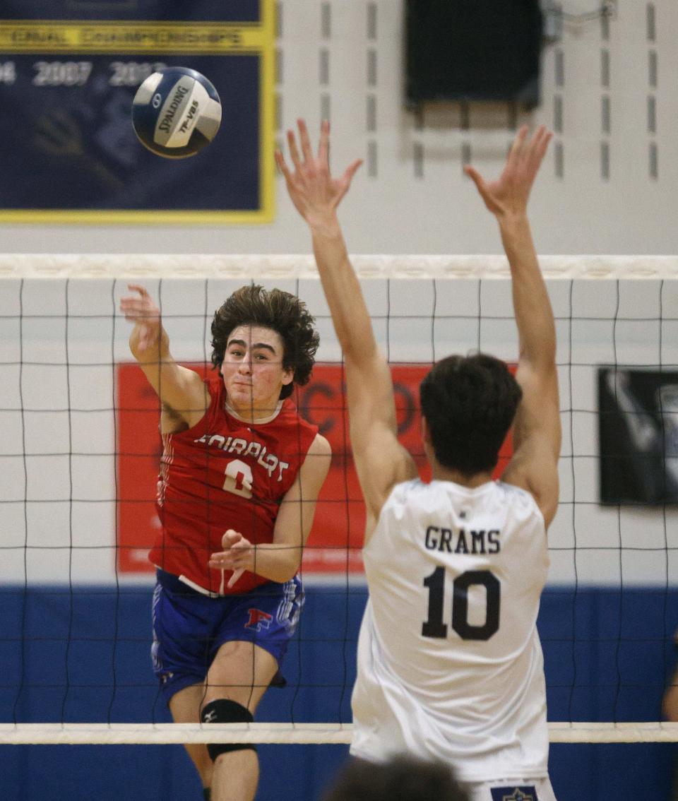 Fairport’s Jackson Bones looks for the kill over Webster’s Jacob Grams. 