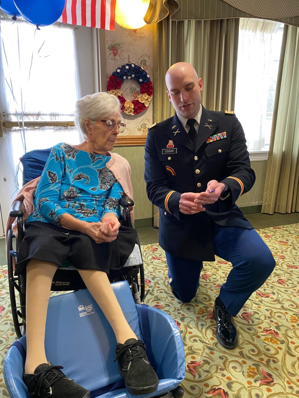 R.I. Army National Guard Capt. Michael Csisar visits Lucille Couture, Lawrence Robidoux’s 97-year-old sister, at Saint Antoine’s Residence in North Smithfield on April 23. On behalf of the secretary of the Army, he offered his condolences to the Robidoux family and presented Lucille with several posthumous awards, including the Prisoner of War Medal.