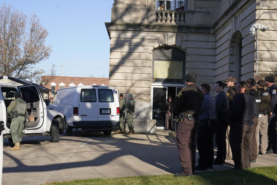 Officers place Richard Matthew Allen into a van outside of the Carroll County courthouse following a hearing, Tuesday, Nov. 22, 2022, in Delphi, Ind. Allen was charged last month with two counts of murder in the killings of Liberty German, 14, and Abigail Williams, 13. (AP Photo/Darron Cummings)