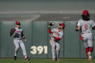 Cincinnati Reds right fielder Jake Fraley, center, catches a fly ball hit by San Francisco Giants' LaMonte Wade Jr. during the fifth inning of a baseball game Saturday, May 11, 2024, in San Francisco. (AP Photo/Godofredo A. Vásquez)