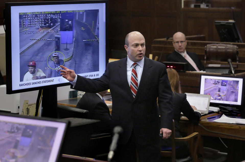 Assistant district attorney Patrick Haggan, center, makes closing arguments in the trial for former New England Patriots tight end Aaron Hernandez, as still images of video surveillance are projected on a screen at Suffolk Superior Court, Thursday, April 6, 2017, in Boston. Hernandez is on trial for the July 2012 killings of Daniel de Abreu and Safiro Furtado who he encountered in a Boston nightclub. The former NFL player is already serving a life sentence in the 2013 killing of semi-professional football player Odin Lloyd. (AP Photo/Steven Senne, Pool)