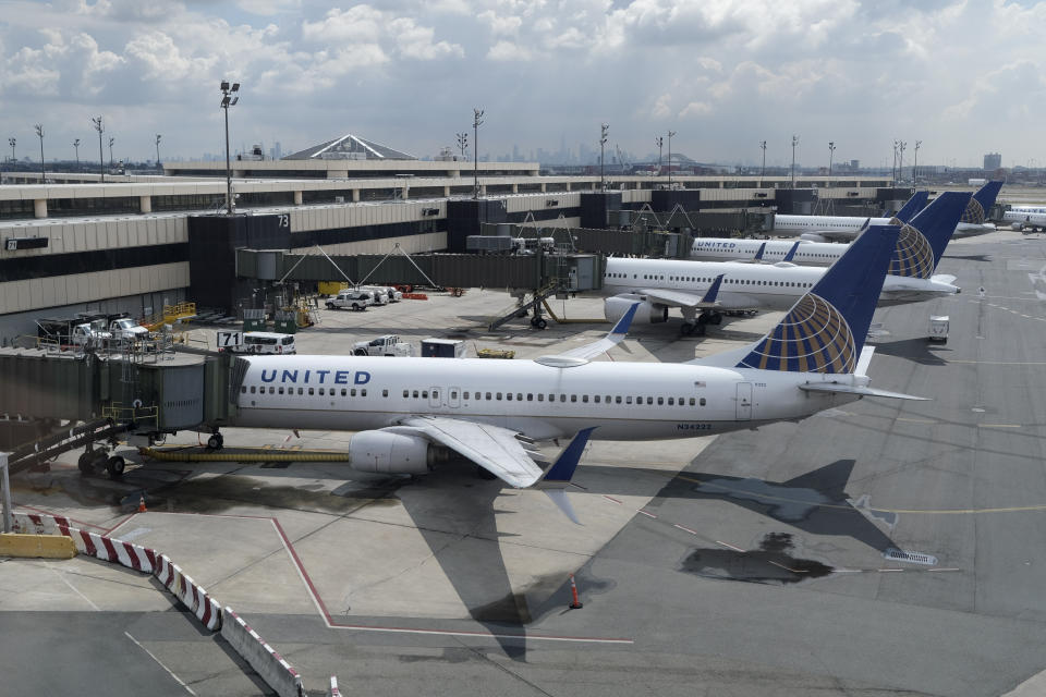 FILE - In this Wednesday, July 1, 2020, file photo, United Airlines planes are parked at gates at Newark Liberty International Airport in Newark, N.J. Congress’ $900 billion pandemic relief package, which passed Monday, Dec. 21, 2020, includes $15 billion for the airline industry and an extension of their Payroll Support Program from the previous rescue bill in March. (AP Photo/Seth Wenig, File)