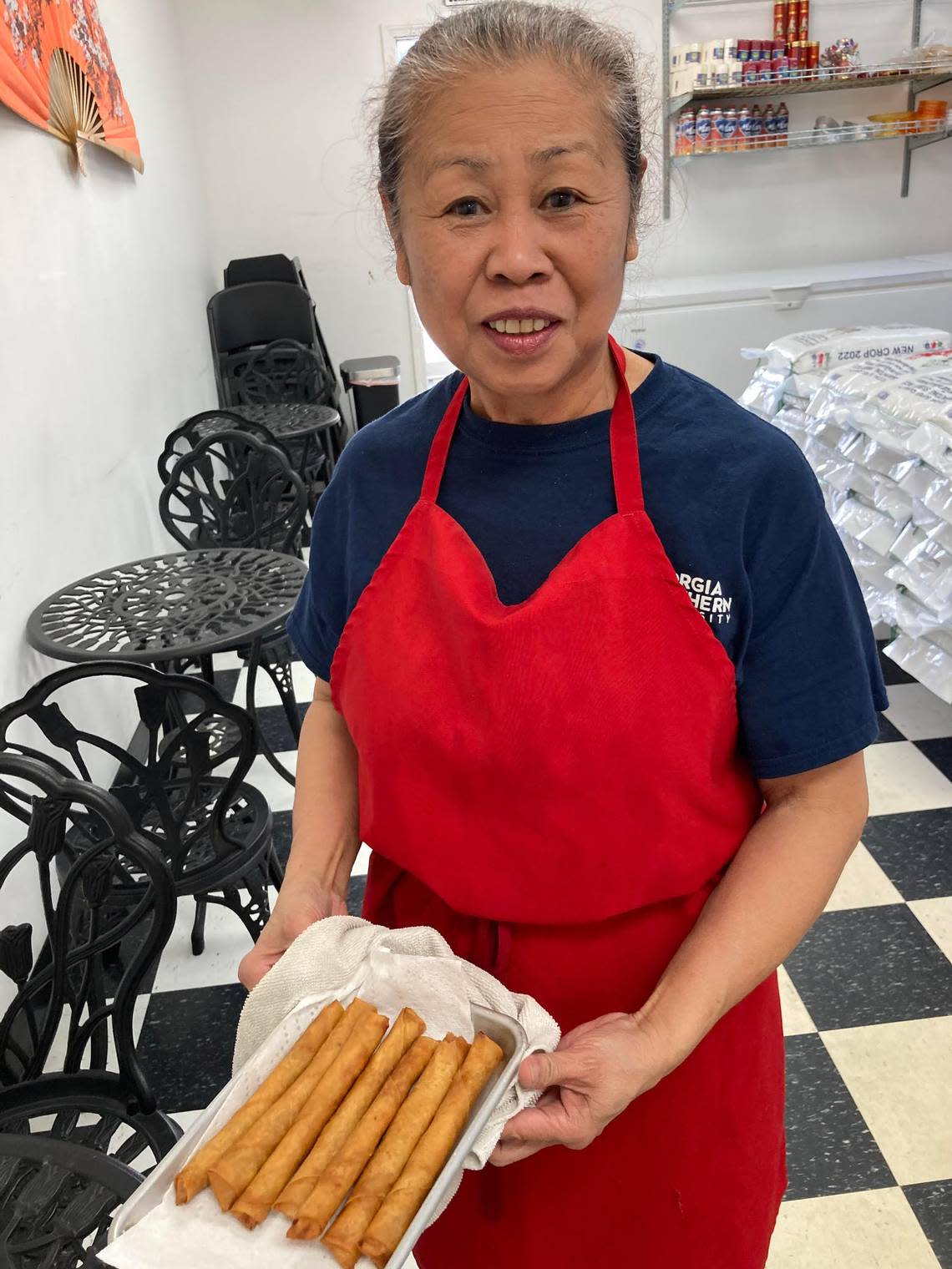 Delia Tropel with a pan of piping-hot lumpia at Lor’s Philippine Cuisine.