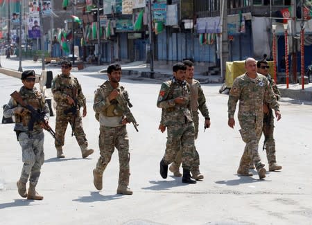 Afghan security forces arrive at the side of a blast in Jalalabad, Afghanistan