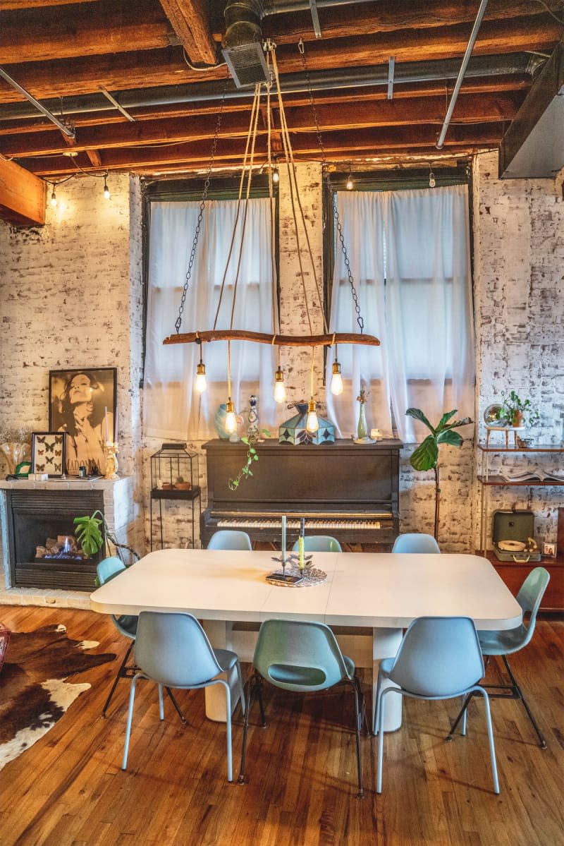 Wooden pendant hung above dining table in loft apartment.