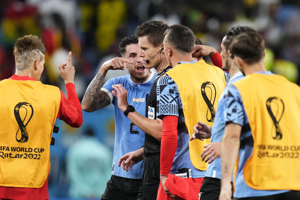 Uruguay's players shout to referee Daniel Siebert after the World Cup group H soccer match between Ghana and Uruguay, at the Al Janoub Stadium in Al Wakrah, Qatar, Friday, Dec. 2, 2022. (AP Photo/Manu Fernandez)