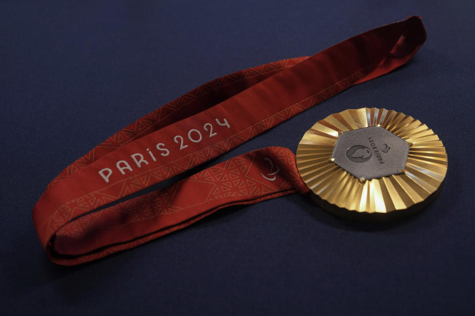 The Paris 2024 Paralympic gold medal is presented to the press, in Paris, Thursday, Feb. 1, 2024. A hexagonal, polished piece of iron taken from the Eiffel Tower is being embedded in each gold, silver and bronze medal that will be hung around athletes' necks at the July 26-Aug. 11 Paris Games and Paralympics that follow. (AP Photo/Thibault Camus)