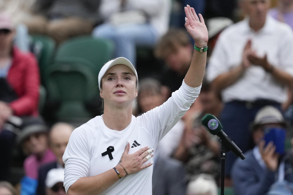 Elina Svitolina of Ukraine waves after defeating Xinyu Wang of China in their fourth round match at the Wimbledon tennis championships in London, Monday, July 8, 2024. (AP Photo/Mosa'ab Elshamy)