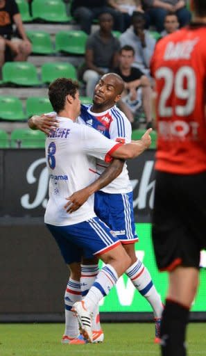 Lyon's French midfielder Yoann Gourcuff (L) celebrates with his teammate Jimmy Briand after scoring during their French L1 football match against Rennes at the route de Lorient stadium in Rennes, western France. Lyon won 1-0