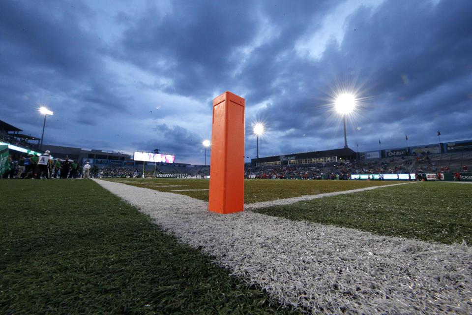 An end zone pylon against an evening sky.