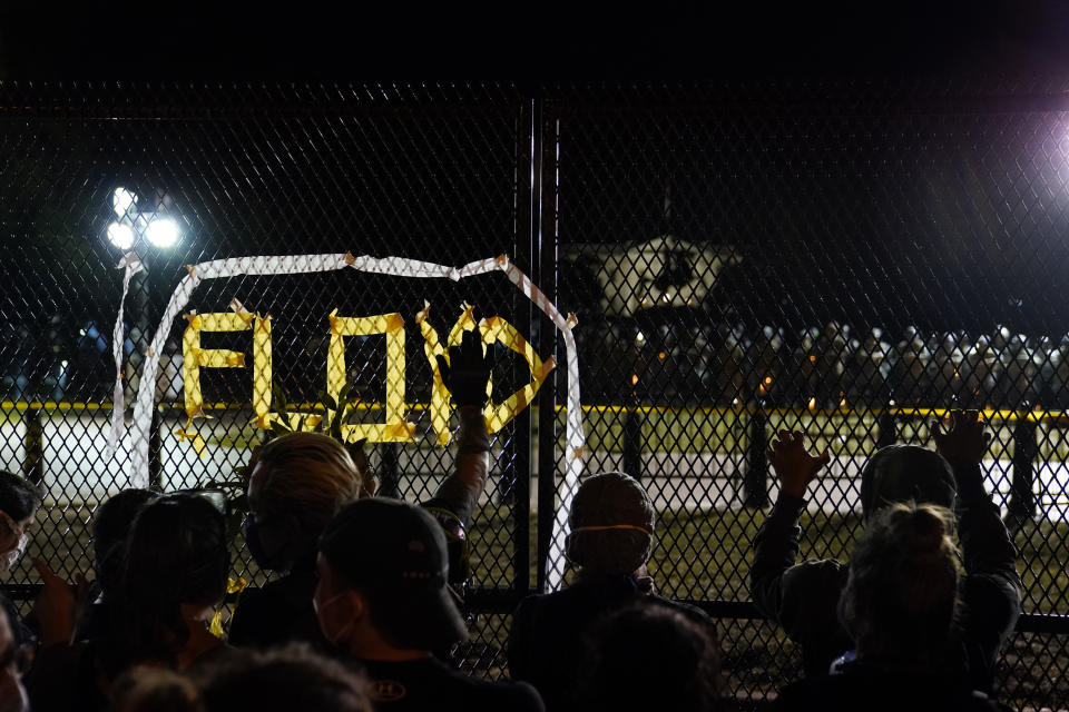 With the White House in the background, a line of police forms behind a fence in Lafayette Park as demonstrators gather to protest the death of George Floyd, Tuesday, June 2, 2020, near the White House in Washington. Floyd died after being restrained by Minneapolis police officers. (AP Photo/Evan Vucci)