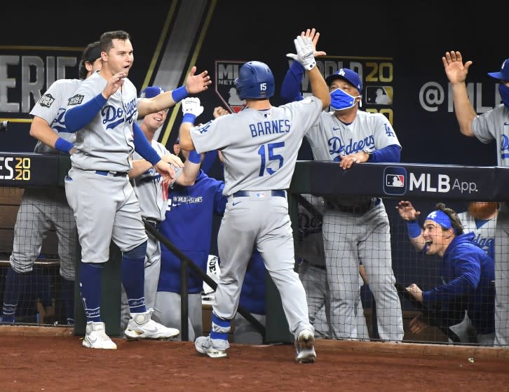 Dodgers manager Dave Roberts, right, greets Austin Barnes after Barnes homered in Game 3 of the World Series.