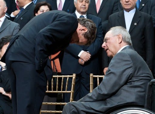 US Treasury Secretary Timothy Geithner speaks with German Finance Minister Wolfgagng Schaueble before the International Monetary and Financial Committee (IMFC) family photo at the IMF/World Bank Annual Spring Meetings in Washington, April 21. The International Monetary Fund wrapped up meetings with its coffers to fight the eurozone crisis $430 billion richer