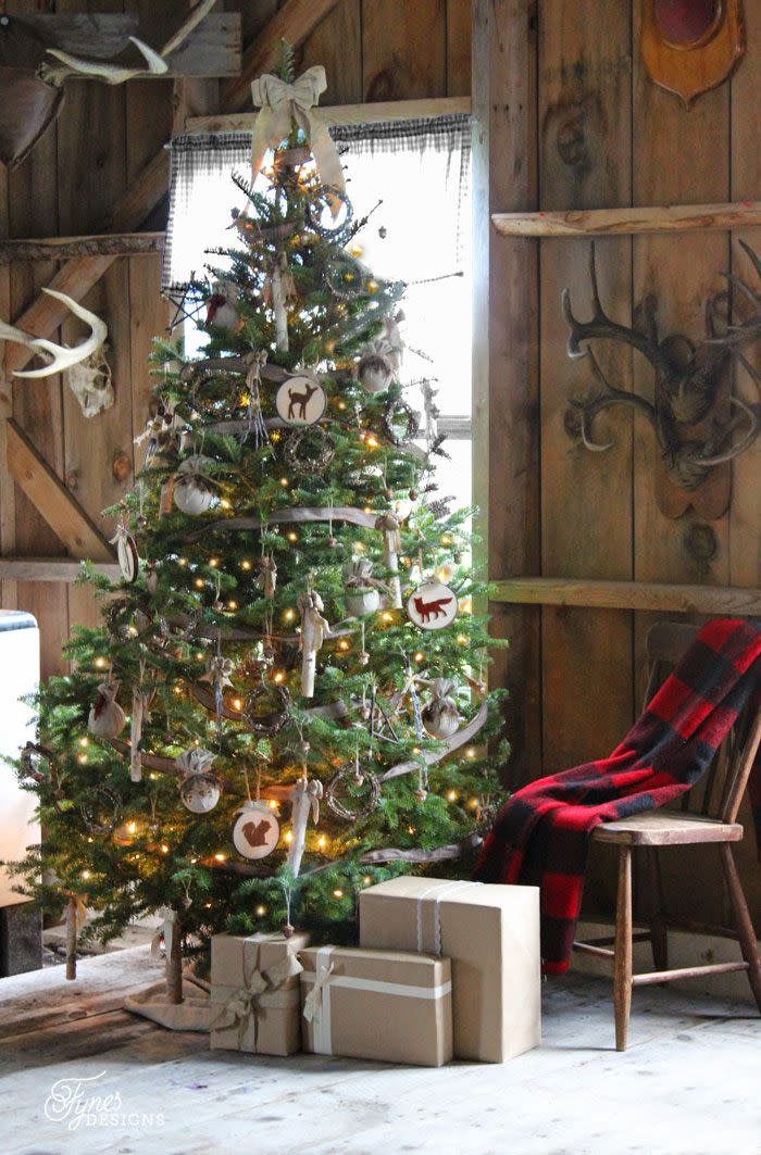 <p>Placed in front of her aunt's vintage enamel wood stove, blogger Virginia Fynes's rustic tree is decorated with birch sticks, glittered acorns and wreaths, hoop art, and feathers. </p><p><strong>Get the tutorial at <a href="http://www.fynesdesigns.com/rustic-christmas/" rel="nofollow noopener" target="_blank" data-ylk="slk:Fynes Designs;elm:context_link;itc:0;sec:content-canvas" class="link ">Fynes Designs</a>.</strong></p><p><a class="link " href="https://www.amazon.com/Wooden-Embroidery-Wholesale-Pieces-Darice/dp/B01M3MPL8J/?tag=syn-yahoo-20&ascsubtag=%5Bartid%7C10050.g.1251%5Bsrc%7Cyahoo-us" rel="nofollow noopener" target="_blank" data-ylk="slk:SHOP EMBROIDERY HOOPS;elm:context_link;itc:0;sec:content-canvas">SHOP EMBROIDERY HOOPS</a></p>
