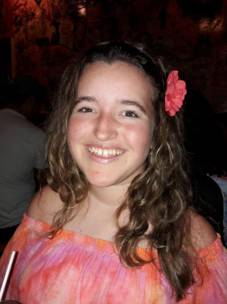 Stella, 15, who has SMA Type 2, is seen smiling with a flower in her hair. Source: Real Press