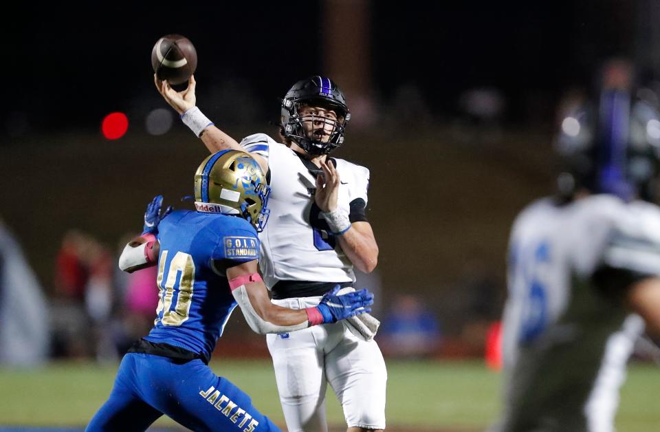 Deer Creek quarterback Grady Adamson (6) passes under pressure from Choctaw's Jacoby McClain (40) during the first half in Choctaw, Okla. on Friday, Oct. 7, 2022.