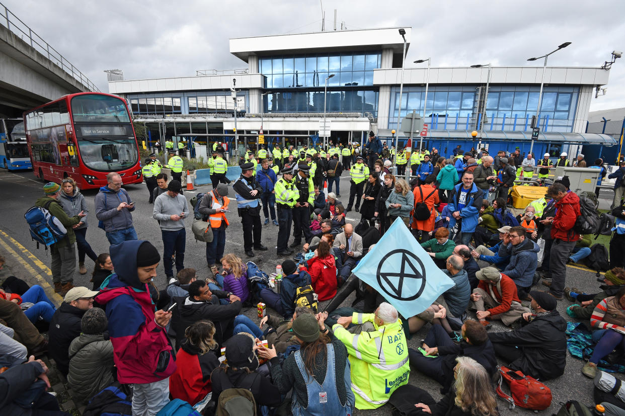 Protesters stage a 'Hong Kong style' blockage of the exit from the train station to City Airport, London, during an Extinction Rebellion climate change protest.