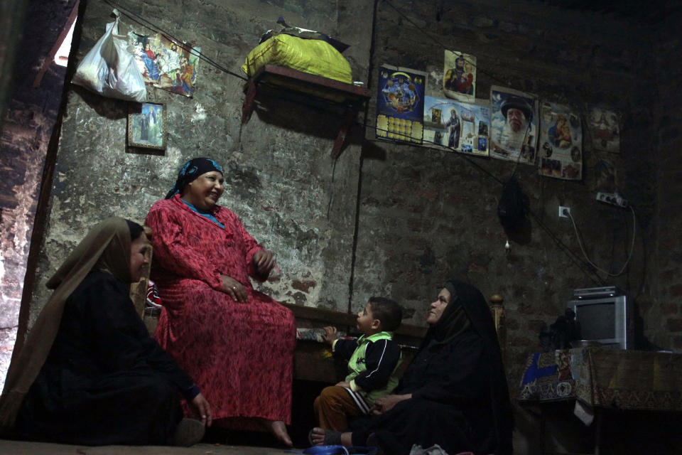 A Christian family sits inside their home in Dalga village of Minya, Egypt, Wednesday, Jan. 15, 2014 on the second day of voting in the country's constitutional referendum. Through violence or intimidation, Islamists in villages like this one used violence or intimidation to stop Christians from voting "no" to a 2012 constitution that had paved the way for the creation of an Islamic state. This time around, no one is stopping the Christians and they are voting "yes" on a new charter that criminalizes discrimination and instructs the next legislature to ease restrictions on building churches. (AP Photo/Roger Anis, El Shorouk Newspaper) EGYPT OUT