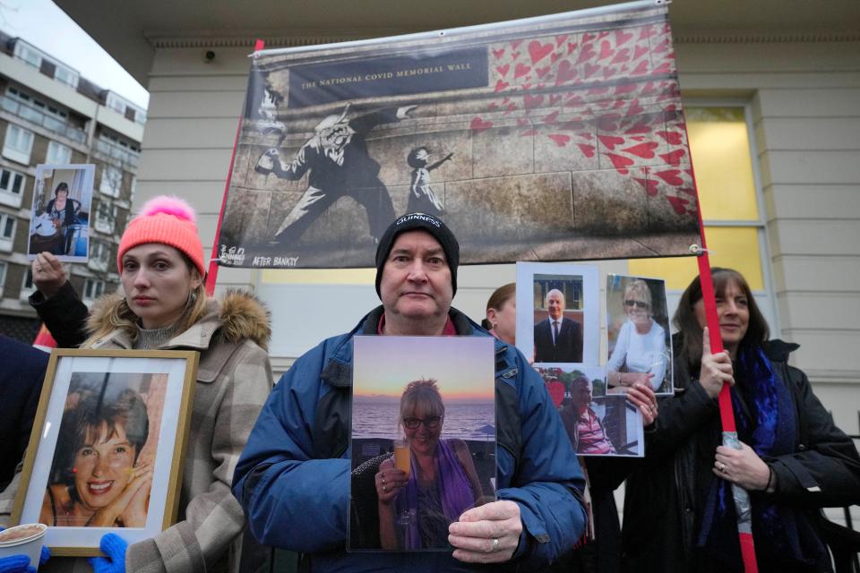 Protesters show pictures of Covid victims outside the UK Covid inquiry as Britain's former Prime Minister Boris Johnson testified (Copyright 2023 The Associated Press. All rights reserved)