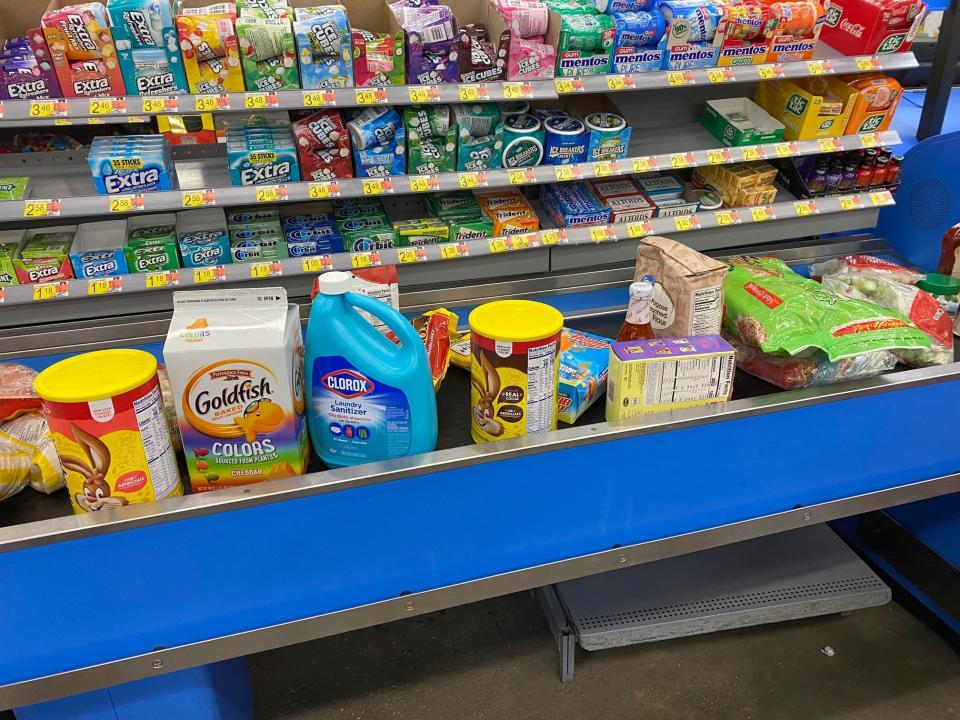 groceries on the conveyor belt at check out at walmart
