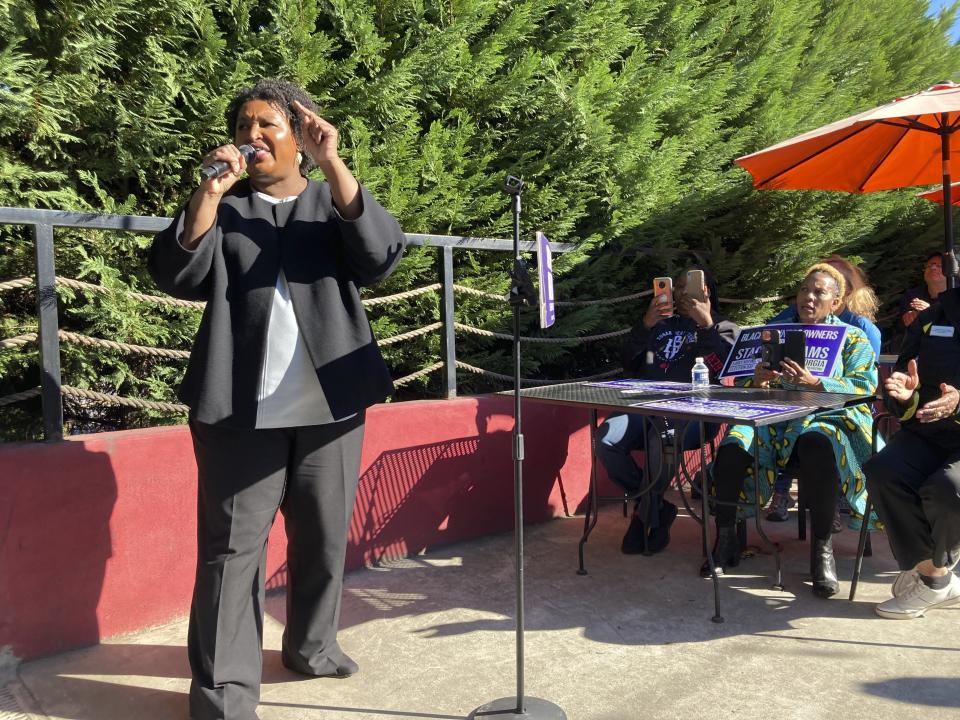 Georgia gubernatorial candidate Stacey Abrams speaks to supporters at a restaurant in College Park, Ga., on Thursday, Oct. 20, 2022. Abrams later appeared with Oprah Winfrey in a prerecorded video interview (AP Photo/Jeff Amy)