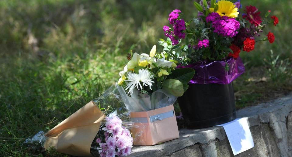 Floral tributes left near Seaford train station where tradie Cam Smith was stabbed.