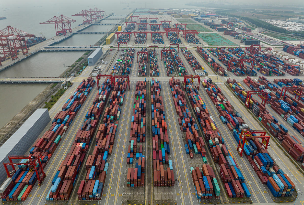 Aerial view of a container yard with hundreds of shipping containers.