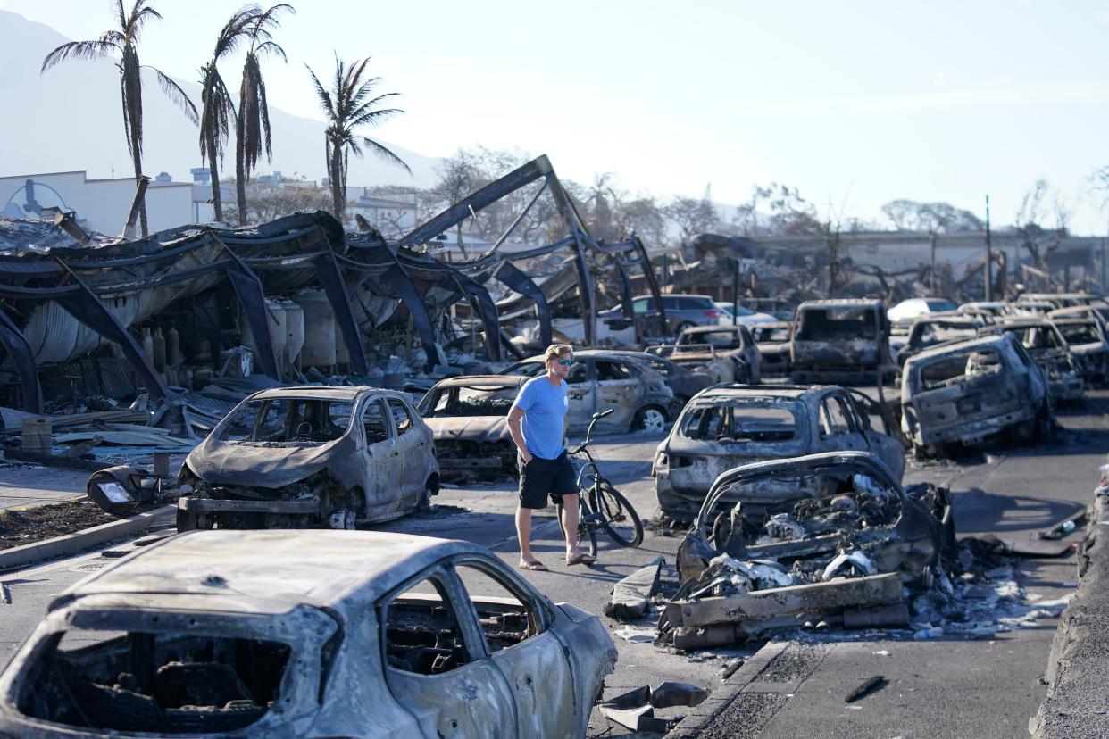 A man walks through wildfire wreckage in Lahaina, Hawaii (Copyright 2023 The Associated Press. All rights reserved)