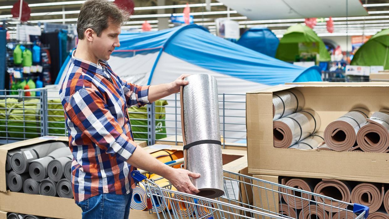 man shopping for camping gear