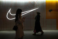 Women walk by a Nike Store at an outdoor shopping mall in Beijing on Saturday, Dec. 23, 2023. It was tumultuous 2023 for the Chinese economy. Some of the world's biggest brands said they were weighing, or already have decided, to shift manufacturing away from China amid unease about security controls, government protection of their Chinese rivals and Beijing's wobbly relations with Washington. But there was at least one bright spot for Beijing amid all the tough news about declining foreign investment: American fast food companies have announced a surge of investment in a market of 1.4 billion people. KFC, McDonald's and Starbucks are among companies in recent months that have announced plans for major investment in China. (AP Photo/Andy Wong)