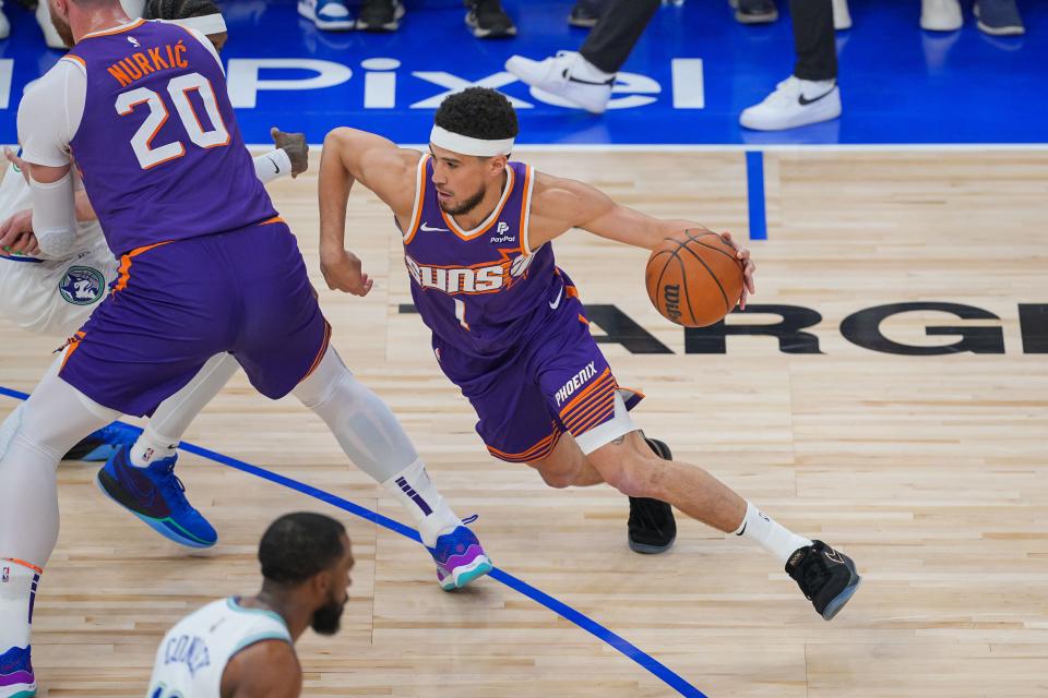 Phoenix Suns guard Devin Booker (1) dribbles against the Minnesota Timberwolves in the first quarter during game two of the first round for the 2024 NBA playoffs at Target Center.