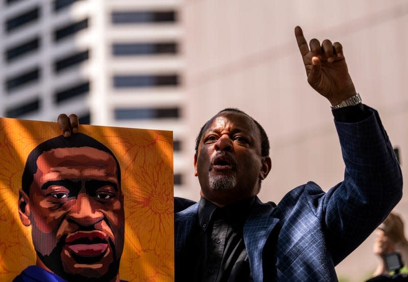 MINNEAPOLIS, MN - JUNE 25: Najee Ali chants, “One down, three to go!” outside the Hennepin County Government Center after the sentencing of Derek Chauvin on June 25, 2021 in Minneapolis, Minnesota. The former Minneapolis Police officer was sentenced to 22.5 years in prison today after being convicted of murder in the death of George Floyd.