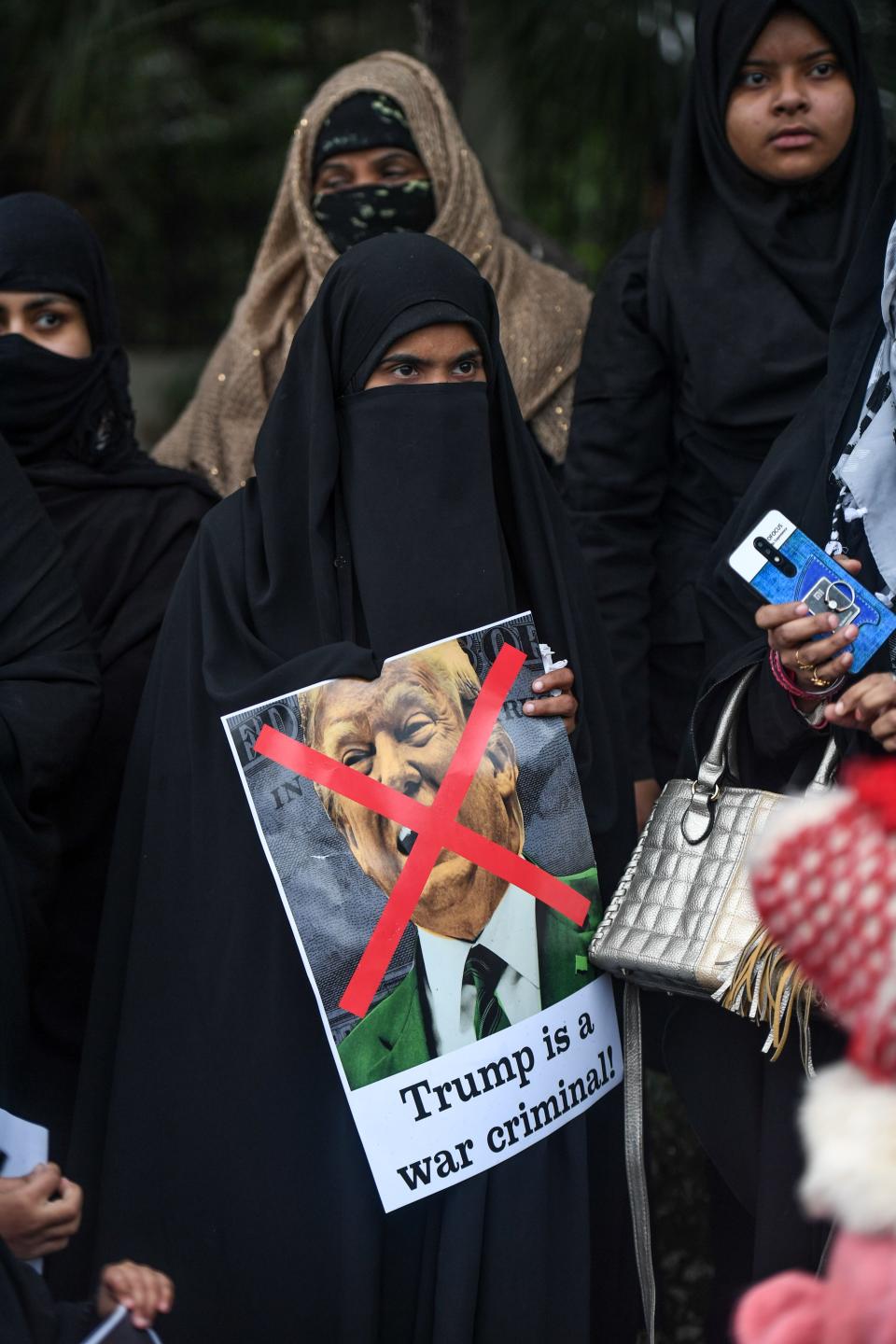 A woman holds a placard to protest against the US authorities for the killing of Iranian commander Qasem Soleimani in Iraq, during a demonstration near the US embassy in New Delhi on January 7, 2020. - A US drone strike killed top Iranian commander Qasem Soleimani at Baghdad's international airport on January 3, dramatically heightening regional tensions and prompting arch enemy Tehran to vow "revenge". (Photo by Prakash SINGH / AFP) (Photo by PRAKASH SINGH/AFP via Getty Images)