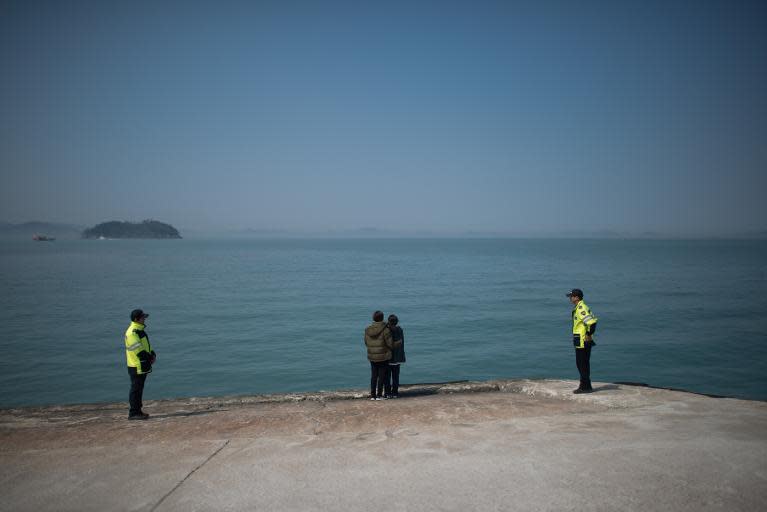 Relatives of missing passengers of the 'Sewol' ferry stand before the sea at Jindo harbour on April 23, 2014