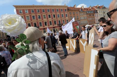 People participate in the protest during the special joint session of Polish parliament, held to mark the centennial of Polish independence and 550 years of parliamentary traditions at the Castle Square in Warsaw, Poland, July 13, 2018. Agencja Gazeta/Slawomir Kaminski via REUTERS