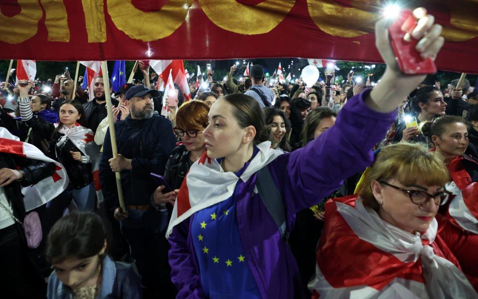 Demonstrators march to protest against the 'foreign influence' law in Tbilisi on Sunday