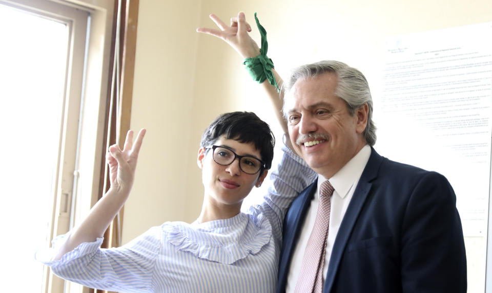 Argentina's presidential front-runner Alberto Fernandez poses for a photo with a student, in his classroom at the University of Buenos Aires School of Law in Buenos Aires, Argentina, Wednesday, Oct. 16, 2019. The presidential ticket headed by Fernandez and his vice presidential running mate, former President Cristina Fernández, no relation, emerged as the strongest vote-getter in Argentina’s primary elections in August, indicating conservative President Mauricio Macri will face an uphill battle going into the Oct. 27 general elections. (AP Photo/Natacha Pisarenko)