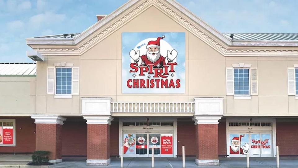 A storefront for Spirit Christmas with a large Santa Claus banner on top