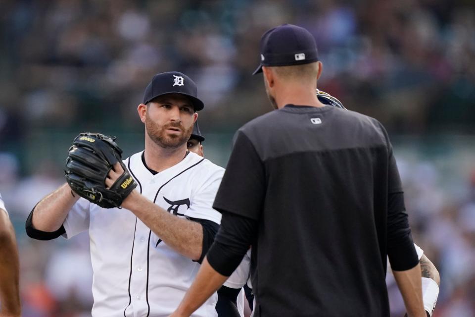 Detroit Tigers starting pitcher Drew Hutchison talks with pitching coach Chris Fetter during the second inning of a baseball game against the Cleveland Guardians, Wednesday, Aug. 10, 2022, in Detroit.