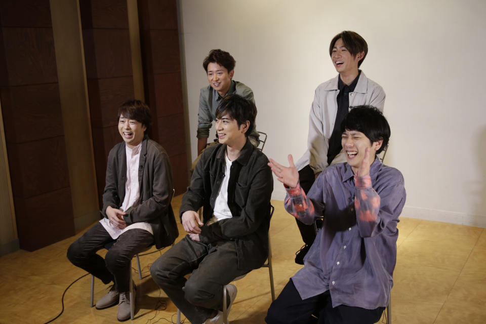 Members of Japanese pop music band ARASHI listen to a question during an interview with The Associated Press in Tokyo on Thursday, Sept. 17, 2020. Back row, from left, clockwise, are Satoshi Ohno, Masaki Aiba, Kazunari Ninomiya, Jun Matsumoto and Sho Sakurai. Japanese pop sensation ARASHI has a big surprise for fans as they near their planned hiatus at year's end: a collaboration with Bruno Mars on their first all-English single. (AP Photo/Hiro Komae)