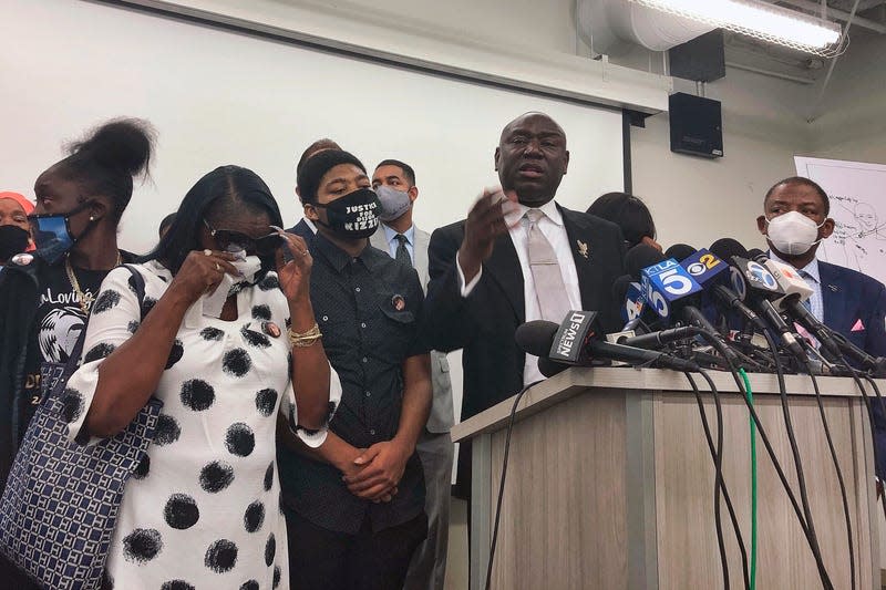 In this Sept. 22, 2020, file photo, attorney Benjamin Crump, at podium, speaks alongside members of Dijon Kizzee’s family during a news conference in Los Angeles. Dijon Kizzee, 29, “posed no threat” to deputies when they fired 19 shots at him, attorney Crump said. An autopsy report says Dijon Kizzee was shot and killed by Los Angeles County sheriff’s deputies, was wounded 16 times in the front and back but it doesn’t shed any light on whether he was on the ground when he was shot. The county coroner’s report supplied to The Associated Press on Friday, Oct. 2, 2020 says Kizzee had four “rapidly life-threatening wounds.” 