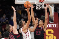 Southern California forward Isaiah Mobley, center, shoots as Stanford forward Lukas Kisunas, left, and forward Brandon Angel defend during the first half of an NCAA college basketball game Thursday, Jan. 27, 2022, in Los Angeles. (AP Photo/Mark J. Terrill)