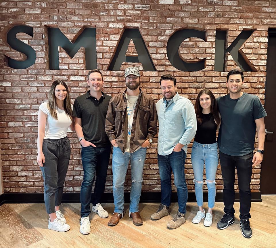 Lakeland native McCoy Moore, 22, center left, has been working for SMACKsongs, a Nashville-based music-publishing, management and artist development company, since December, but his contract wasn't official until July.