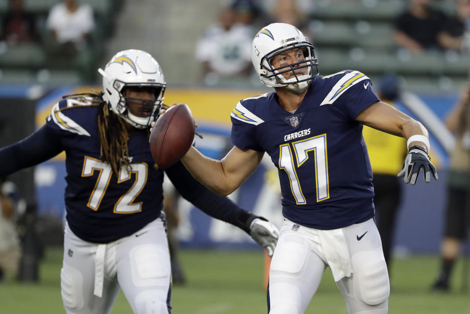 Los Angeles Chargers quarterback Philip Rivers looks to throw a pass as offensive tackle Joe Barksdale (72) protects during the first half of an NFL preseason football game against the Seattle Seahawks on Saturday, Aug. 18, 2018, in Carson, Calif. (AP Photo/Gregory Bull)